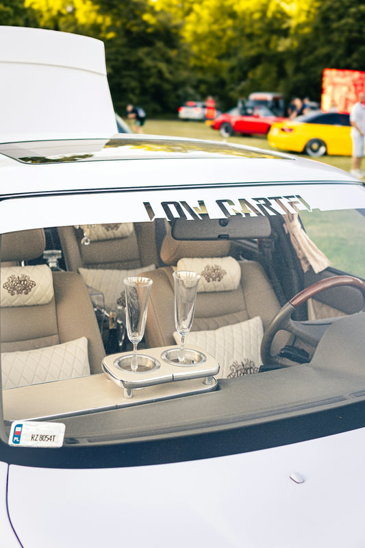 Champagne glasses inside a car at an event